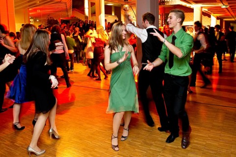 Young couple dancing at the prom of a dance school