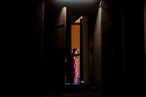 Monk leaving the room of a temple in Punakha Dzong fortress