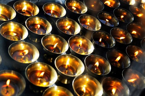 Yak butter lamps burning at a shrine en route to the monastery and temple complex of Taktshang-Lhakang