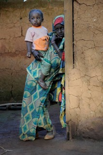 Young girl holding her younger sister in the village of Idool