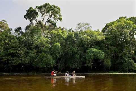 Tourists being rowed across the Nyong River