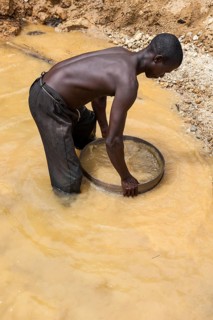 Worker washing gravel at a diamond mine