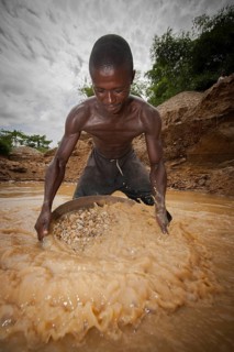 Worker washing gravel at a diamond mine