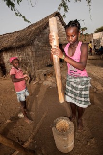 Women of the Rabelados religious community pounding corn in a mortar