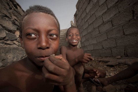 Children of the Rabelados religious community eating sea snails