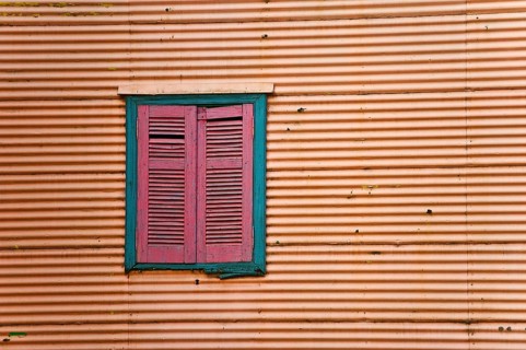 Closed shutters in a corrugated iron facade