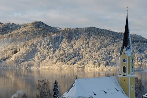 Lake Schliersee with the Church of St. Sixtus in winter