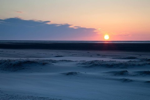 Sunset over the sand dunes on the Nordstrand beach