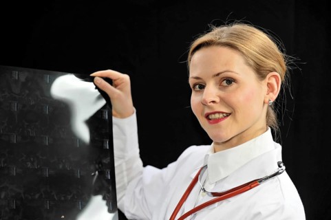 Young female doctor holding an X-ray