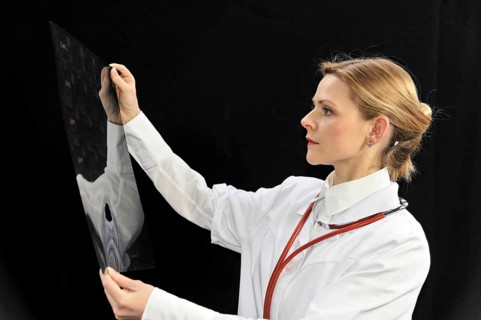 Young female doctor holding an X-ray