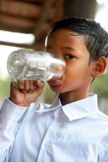 Boy drinking water from a glass
