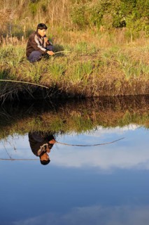 Indigenous man fishing in a pond in the community of Mbya-Guarani Indians