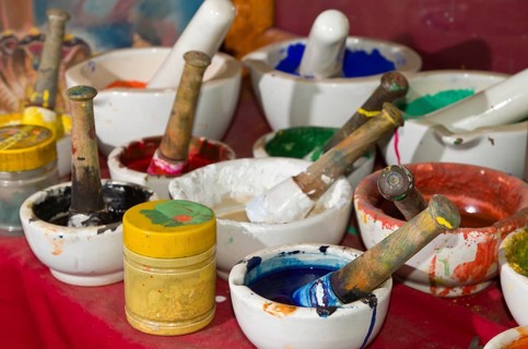 Different bowls with natural colors for painting Thangkas at an art school