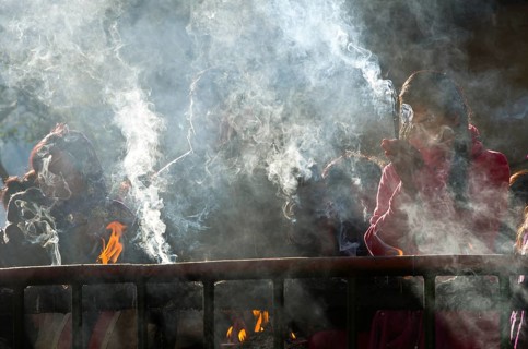 Pilgrims burning incense as an offering