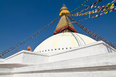 Young woman practicing yoga at the Boudnanath stupa
