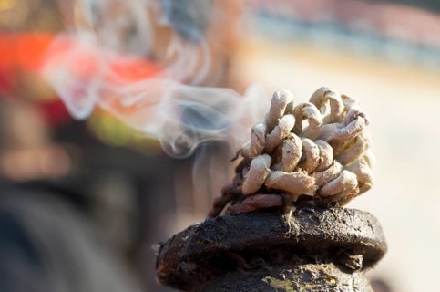 Incense burning in front of a Ganesha shrine