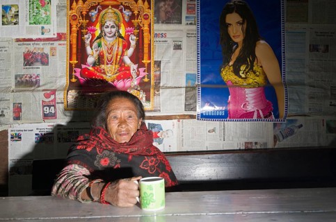 Old woman drinking tea in a local restaurant