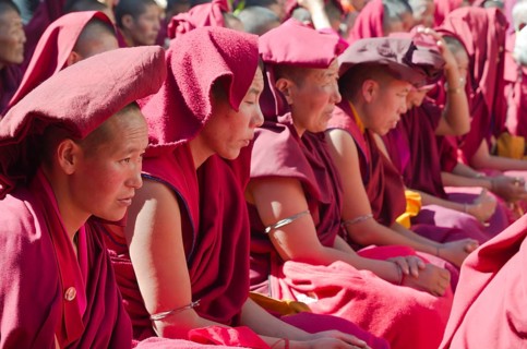 Many nuns wearing red cloths listening the teachings of Taklung Tsetru Rinpoche in the backyard of Junbesi Gompa