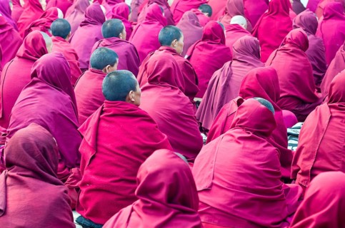 Many nuns wearing red cloths listening the teachings of Taklung Tsetru Rinpoche in the backyard of Junbesi Gompa