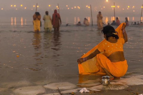 Woman washing her sari in the Sangam