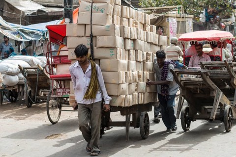 Men transporting goods on a hand cart on Khari Baoli Road