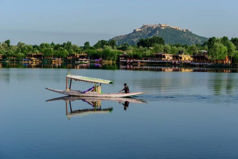 A shikara boat crossing Dal Lake