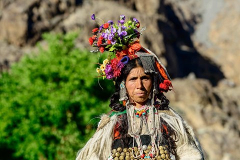 Woman of the Brokpa tribe wearing traditional dress with flower headdress
