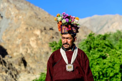 Man of the Brokpa tribe wearing traditional dress with flower headdress