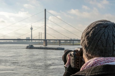 Young woman taking photographs of the Rhine