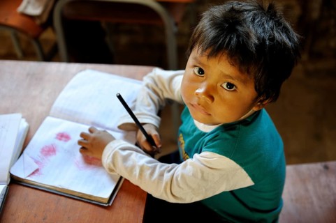 Boy with a book in a classroom