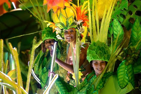 Dancers in colourful costumes on floats