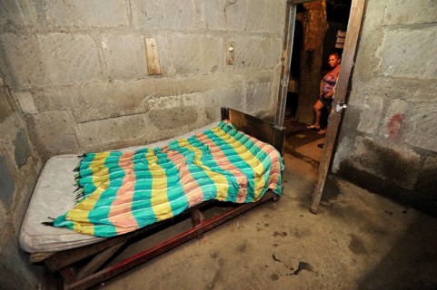 Basic room with a bed in a cheap brothel on the outskirts of the city