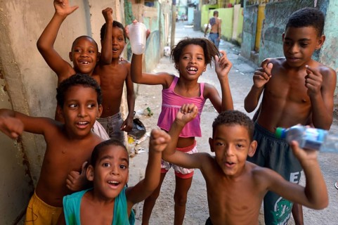 Children cheering happily in a slum or favela