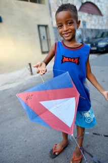 Young boy holding a kite in a slum or favela