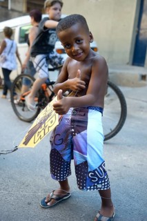 Young boy holding a kite in a slum or favela