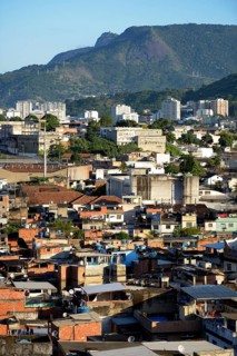 View over a slum or favela towards the high-rise apartment buildings where the urban middle class live