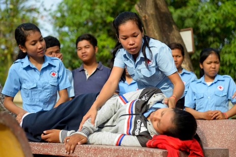 Young woman positioning a patient in the recovery position