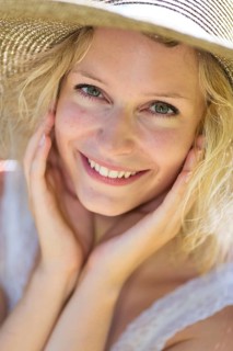 Smiling young woman with summer hat
