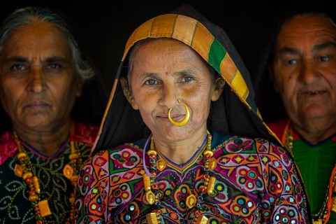 Elderly Ahir woman in traditional colorful clothes with a nose ring