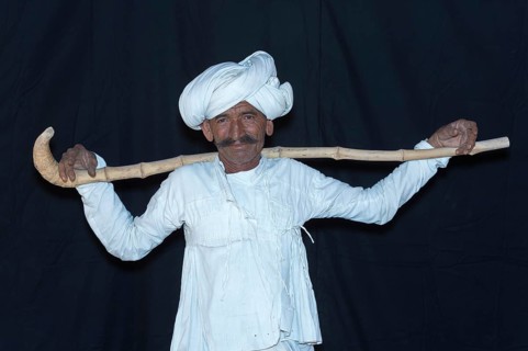 Rabari Man wearing a white clothes with turban and holding walking stick