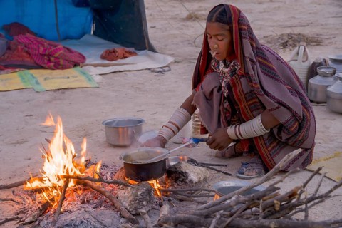 Fakirani woman cooking at a wood fire camp