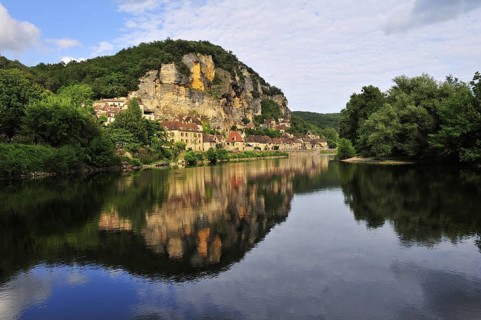 The village of La Roque-Gageac reflected in the water of the Dordogne river