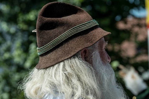 Old man with long gray hair and a traditional Bavarian hat