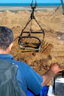 Excavator operator in the cab of a dragline excavator working in the diamond mine of De Beers Namaqualand Mines