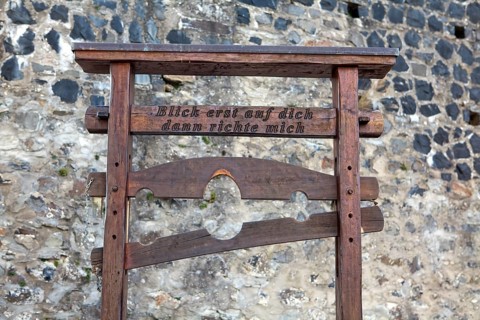 Pillory from the Middle Ages with the inscription 'Blick erst auf dich