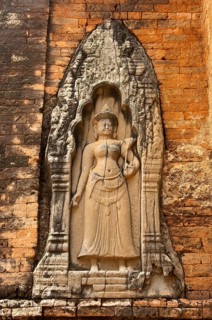 Bas-relief of a female deity wearing a long robe and holding a fly-whisk in her hand