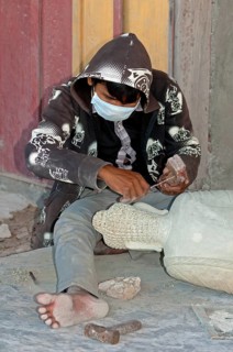 Stonemason working on a Buddha statue