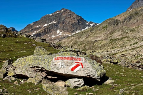 White-red-white markings of hiking trail and a signpost to Loetschen Pass