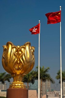 Sculpture of a gilded eternal Bauhinia flower with the flags of Hong Kong and China