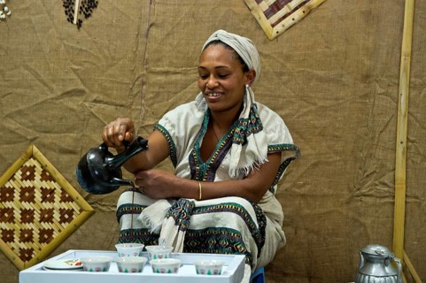 Ethiopian woman pours coffee in a traditional coffee ceremony